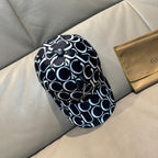 Gucci cap with black crown, black-and-white GG logo pattern, and button top detail