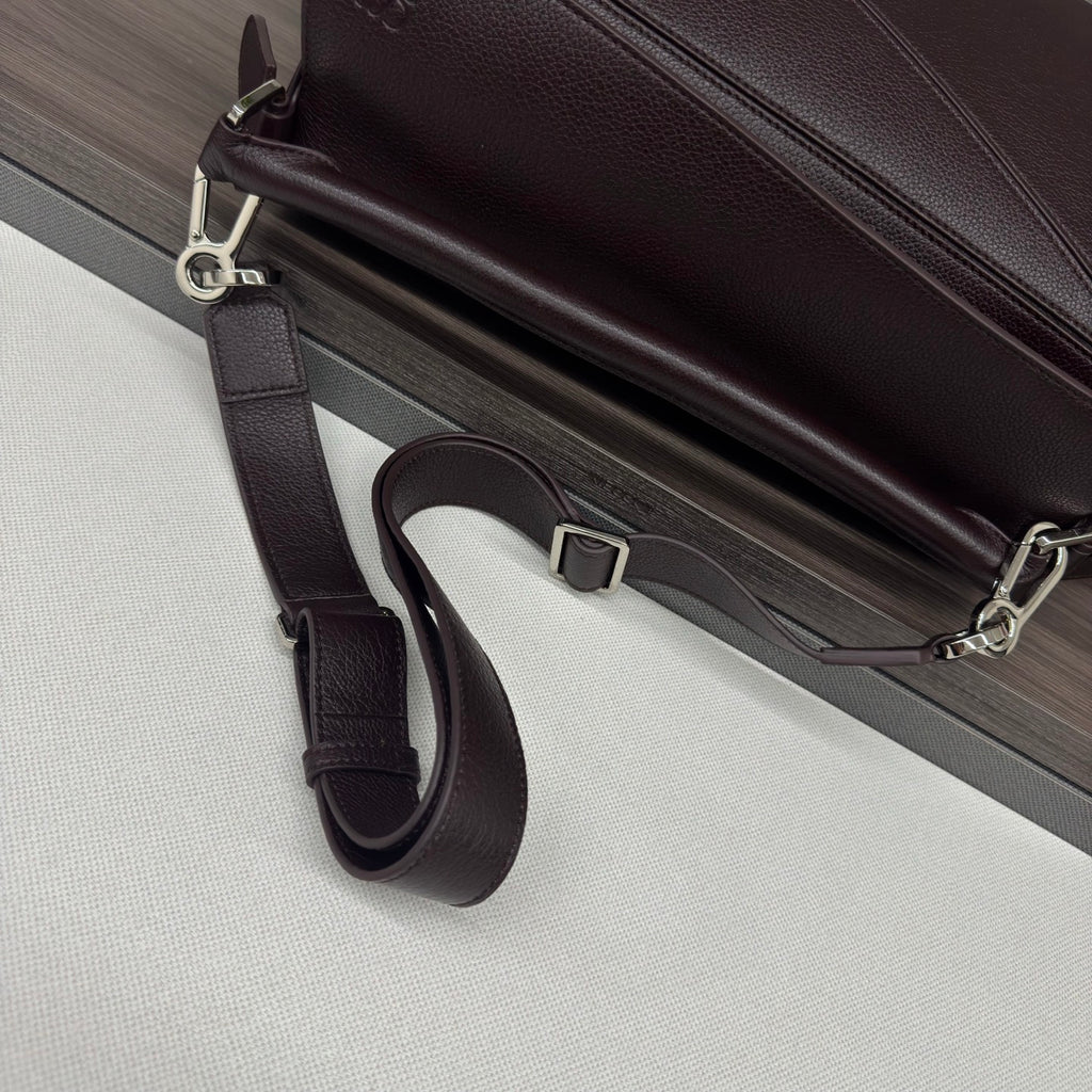 Loewe dark brown leather bag with adjustable crossbody strap and silver buckle