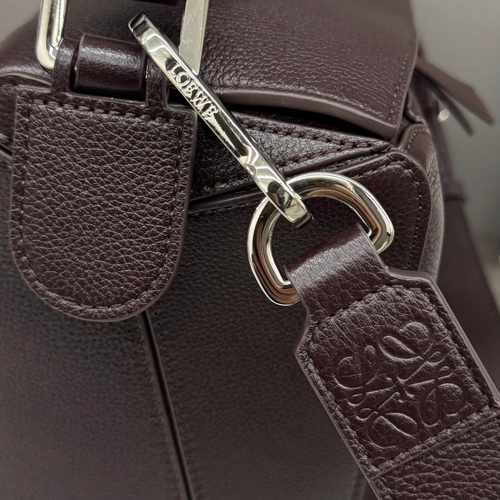 Loewe dark brown leather bag with metal rings and embossed leather tag