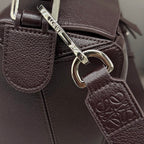 Loewe dark brown leather bag with metal rings and embossed leather tag