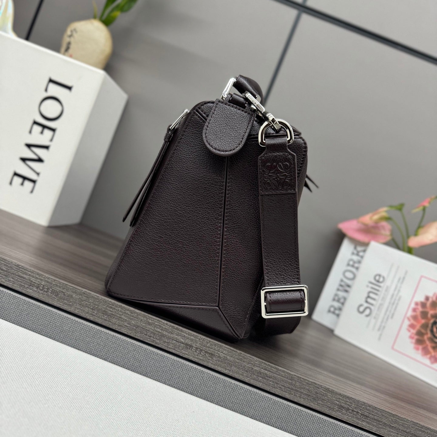 Loewe dark brown leather crossbody bag with flap, snap closure, and ring strap
