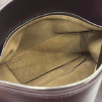Loewe bag interior with tan suede lining and stitched logo patch