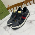 Gucci unisex denim sneakers, dark blue with red-and-blue stripe panel, gold lace eyelets