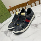 Gucci unisex denim sneakers, dark blue with red-and-blue stripe panel, gold lace eyelets
