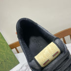 Gucci unisex sneaker insole detail, embossed logo on beige patch, dark blue upper