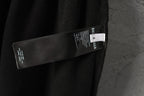 Black pants with Balenciaga label and care tag near side seam