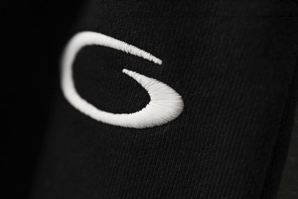 Black pants with large white logo stitch detail
