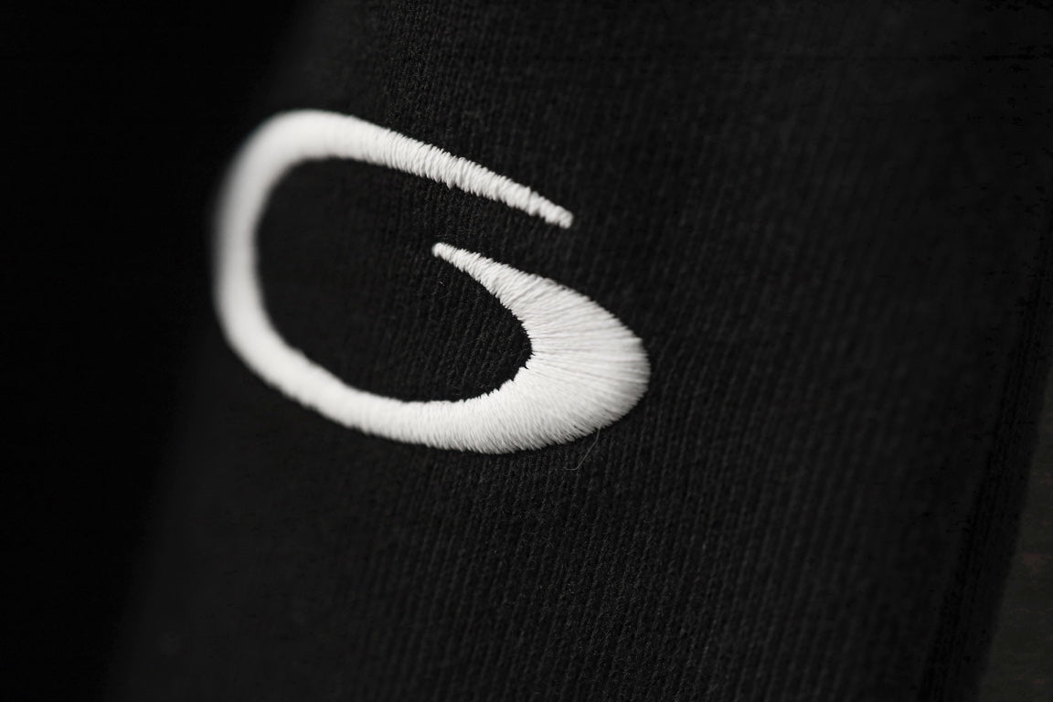 Black pants with close-up white embroidered logo