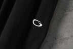 Black pants fabric with small white logo detail