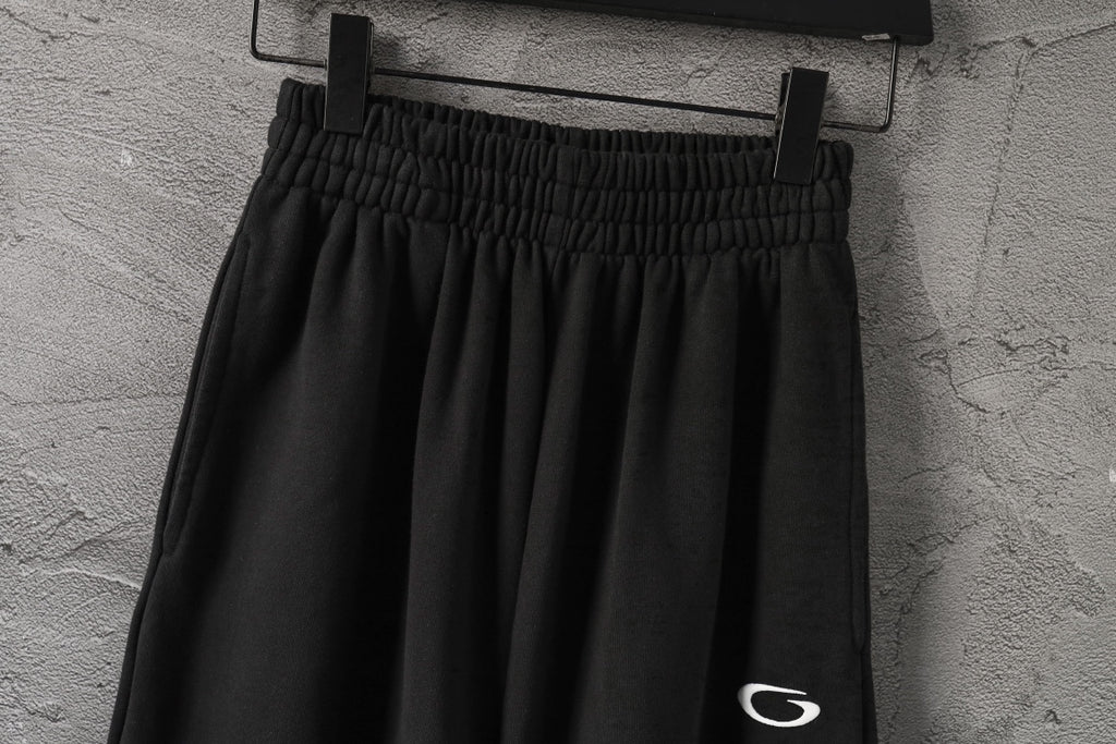 Black wide-leg pants with gathered elastic waist and small side logo