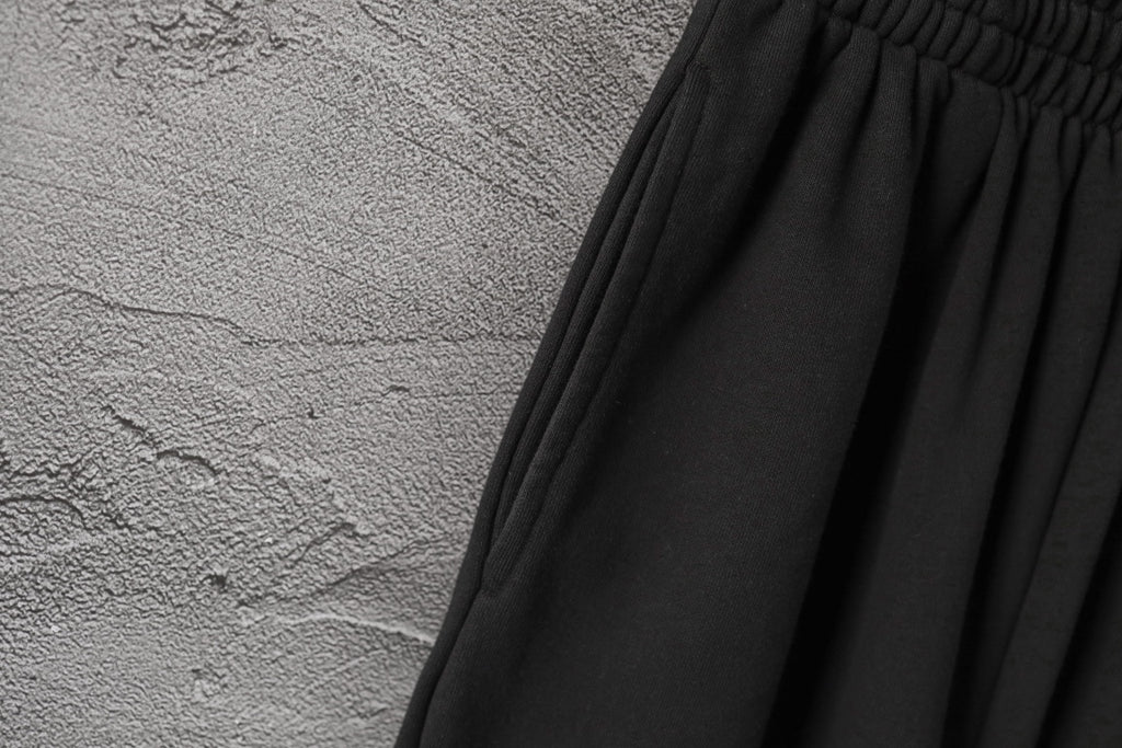 Black gathered waistband with pleated fabric panels