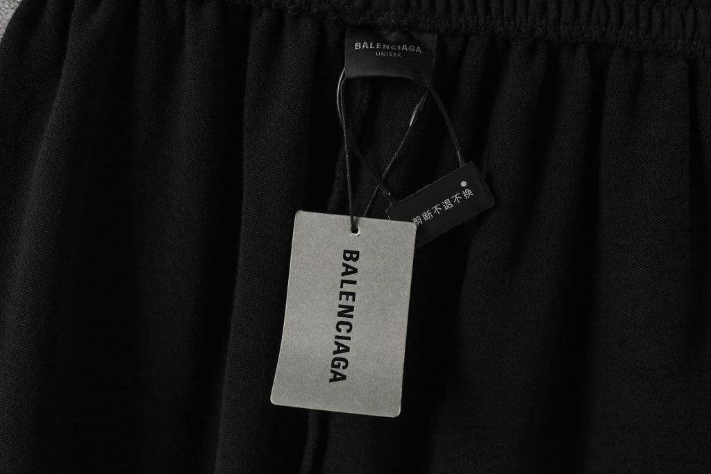 Black pants with Balenciaga hang tag and waistband detail