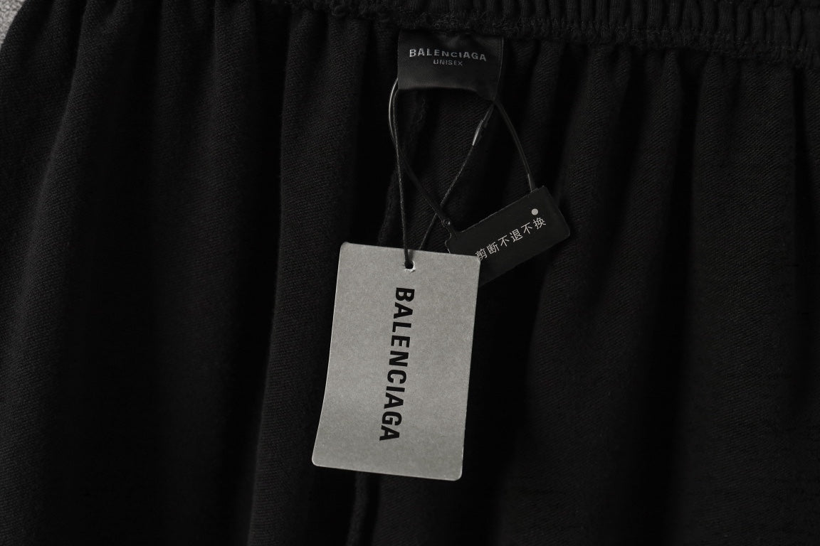 Black pants with hanging retail tags and small logo on waistband