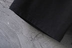 Black pants hem with visible seam stitching