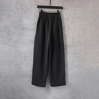 Black wide-leg pants with elastic waistband and relaxed straight leg