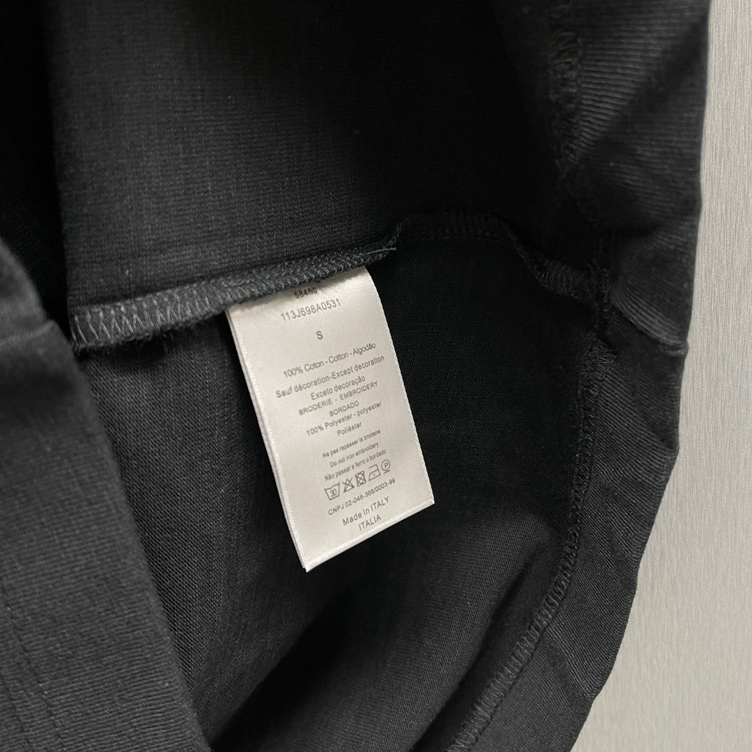 Black T-shirt with white size/care label at inside neckline