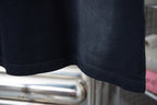 Dark short-sleeve T-shirt hem seam detail.