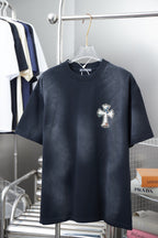 Dark short-sleeve T-shirt with small cross logo on the chest.
