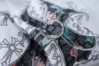 Close-up of cross graphic embroidery on a white T-shirt