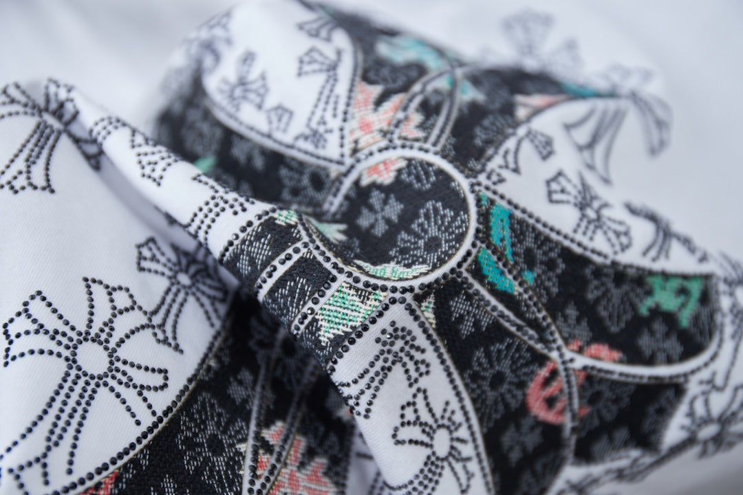 Close-up of cross graphic embroidery on a white T-shirt