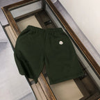 Stone Island dark green shorts with elastic waistband and small front logo patch