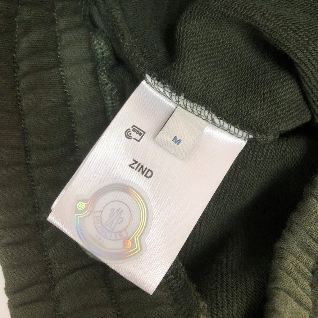 Stone Island dark green shorts size label with ZIND and M marking