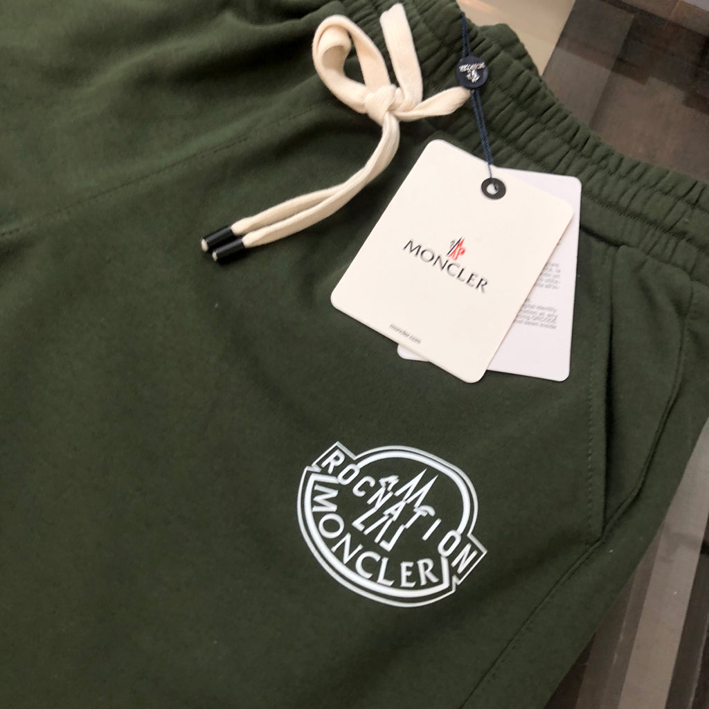 Stone Island dark green shorts close-up with drawstring and circular front logo patch