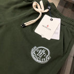 Stone Island dark green shorts close-up with drawstring and circular front logo patch