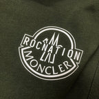 Stone Island dark green shorts with large circular Rocket logo graphic