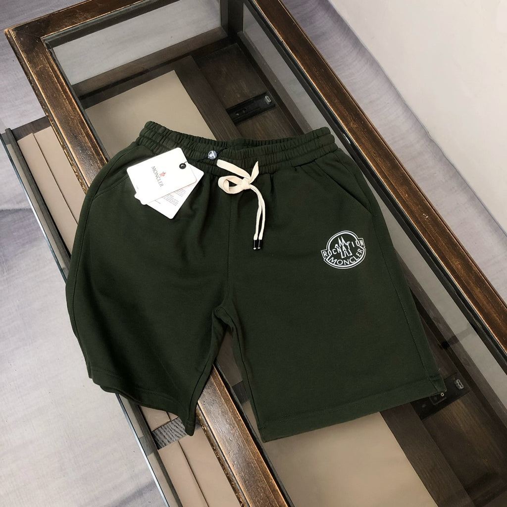 Stone Island dark green shorts with drawstring and circular logo patch on front