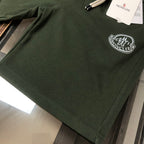 Stone Island dark green shorts with circular logo patch on front hem