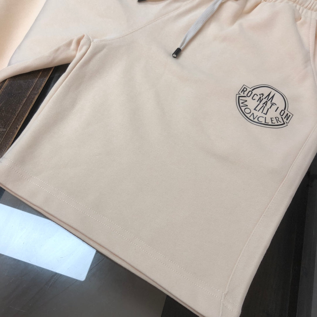 Cream shorts with front logo patch and stitched hem detail