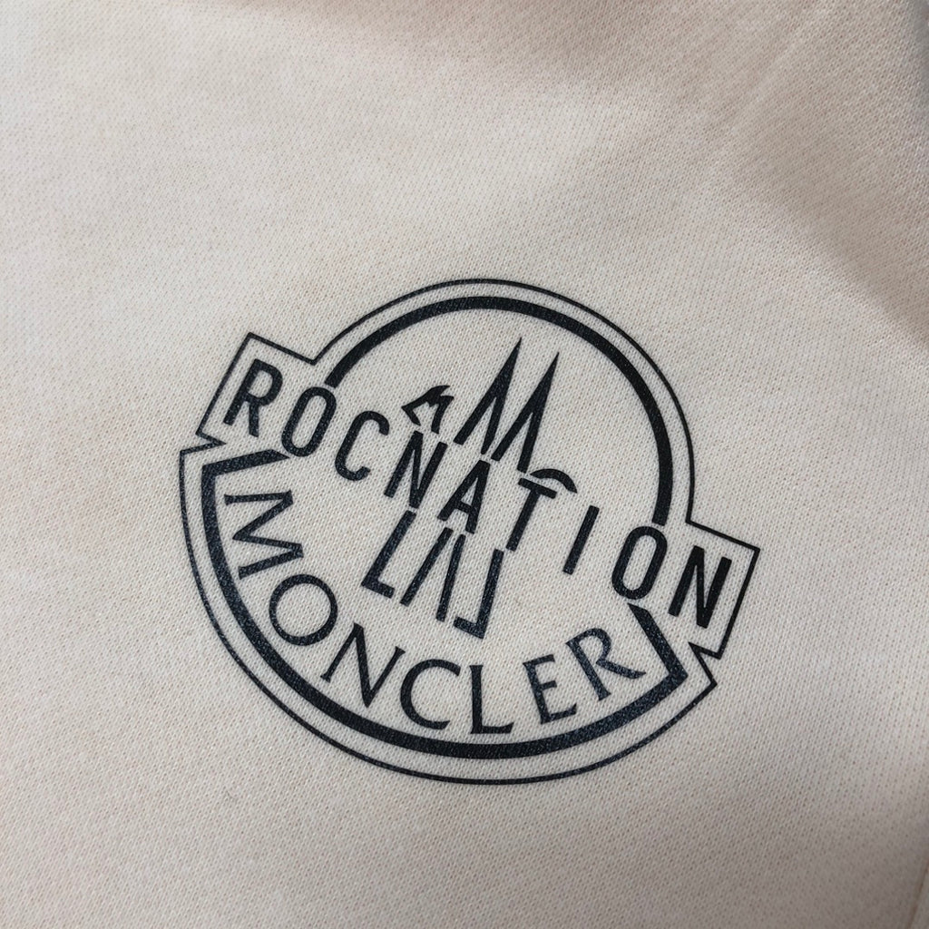 Embroidered round logo patch with MONCLER text on light fabric