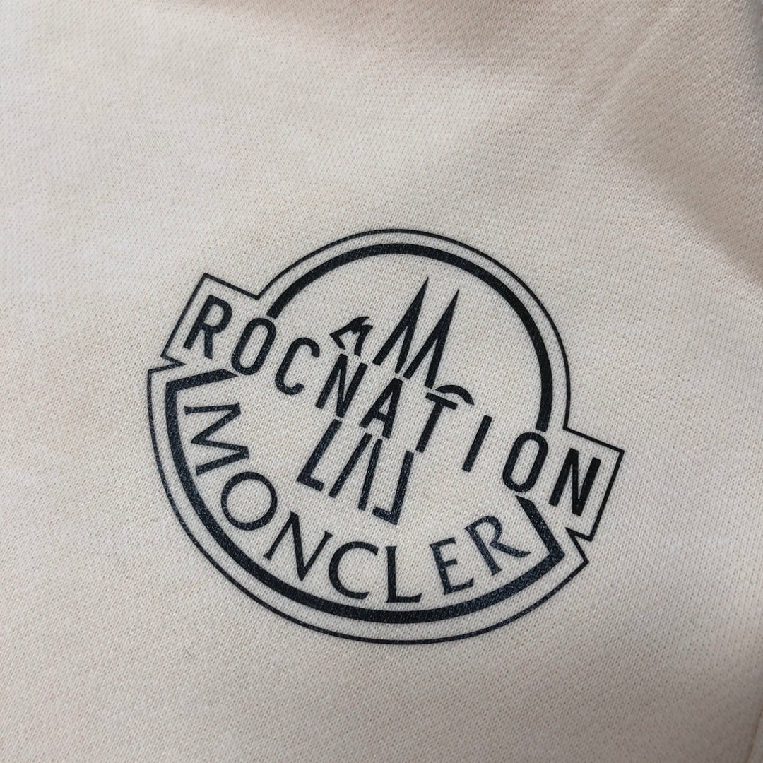 Embroidered round logo patch with MONCLER text on light fabric