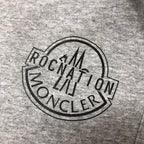 Close-up of circular logo on heather gray shorts