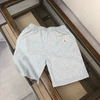 Light gray shorts with small logo patch on back and elastic waist
