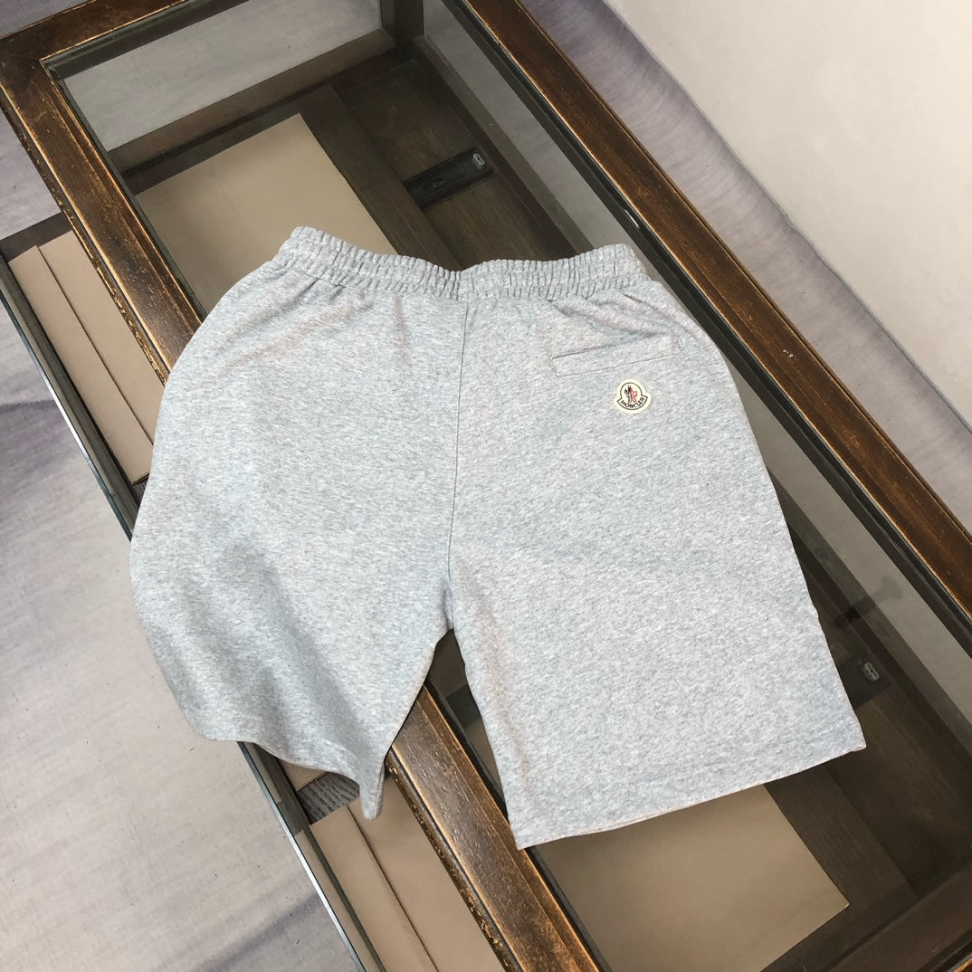 Light gray shorts with small logo patch on back and elastic waist