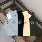 Set of drawstring shorts in light gray, black, cream, and dark green