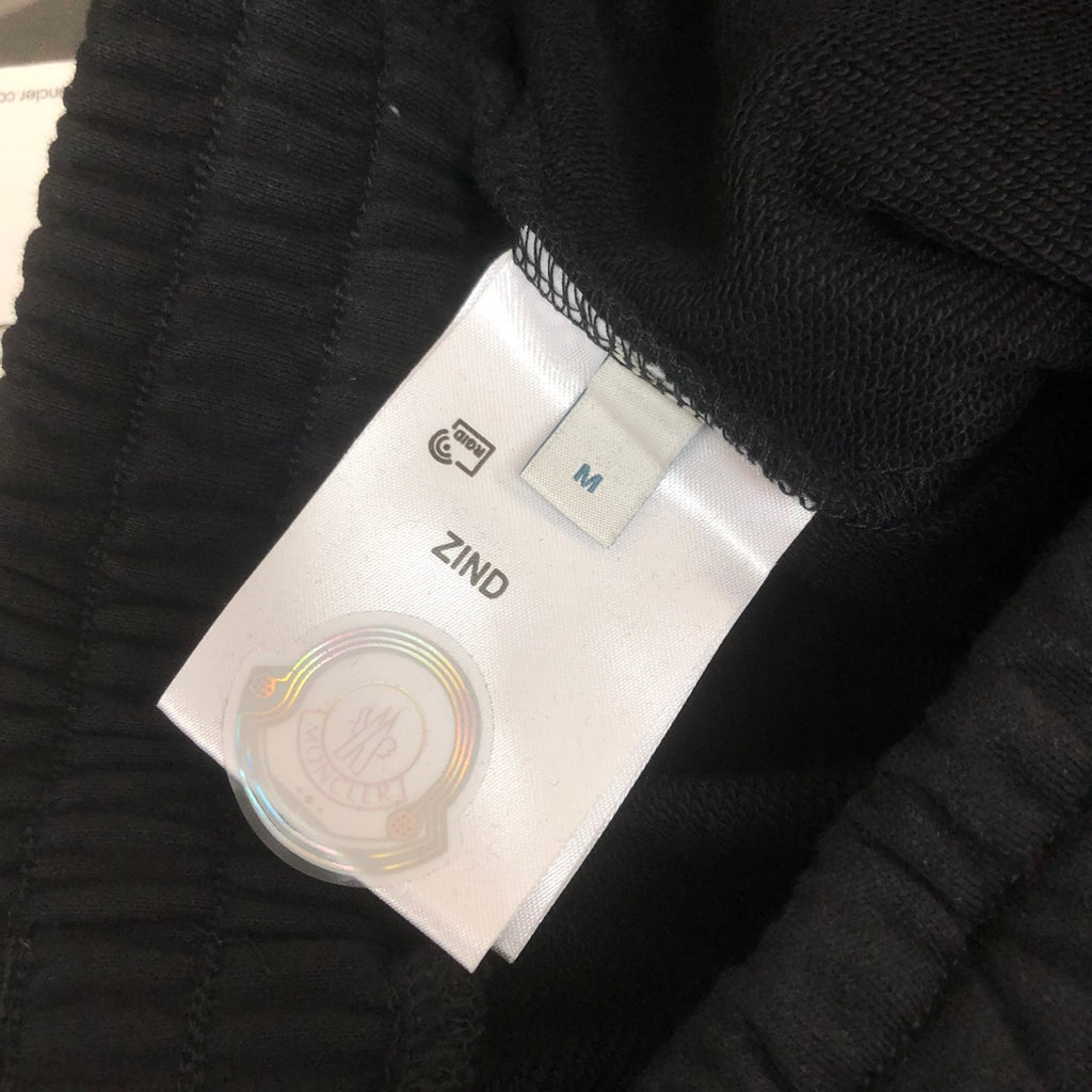 Stone Island fabric label on black drawstring shorts, size M