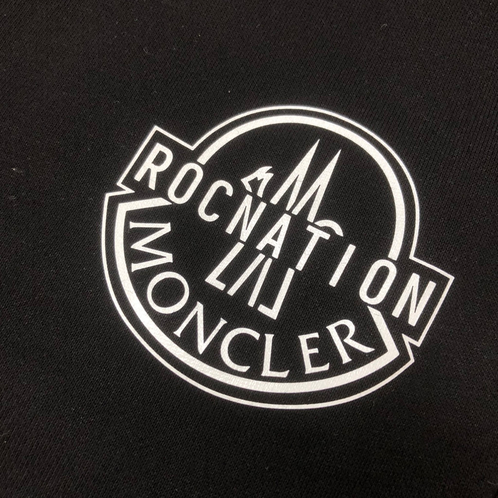 Stone Island logo patch on black fabric