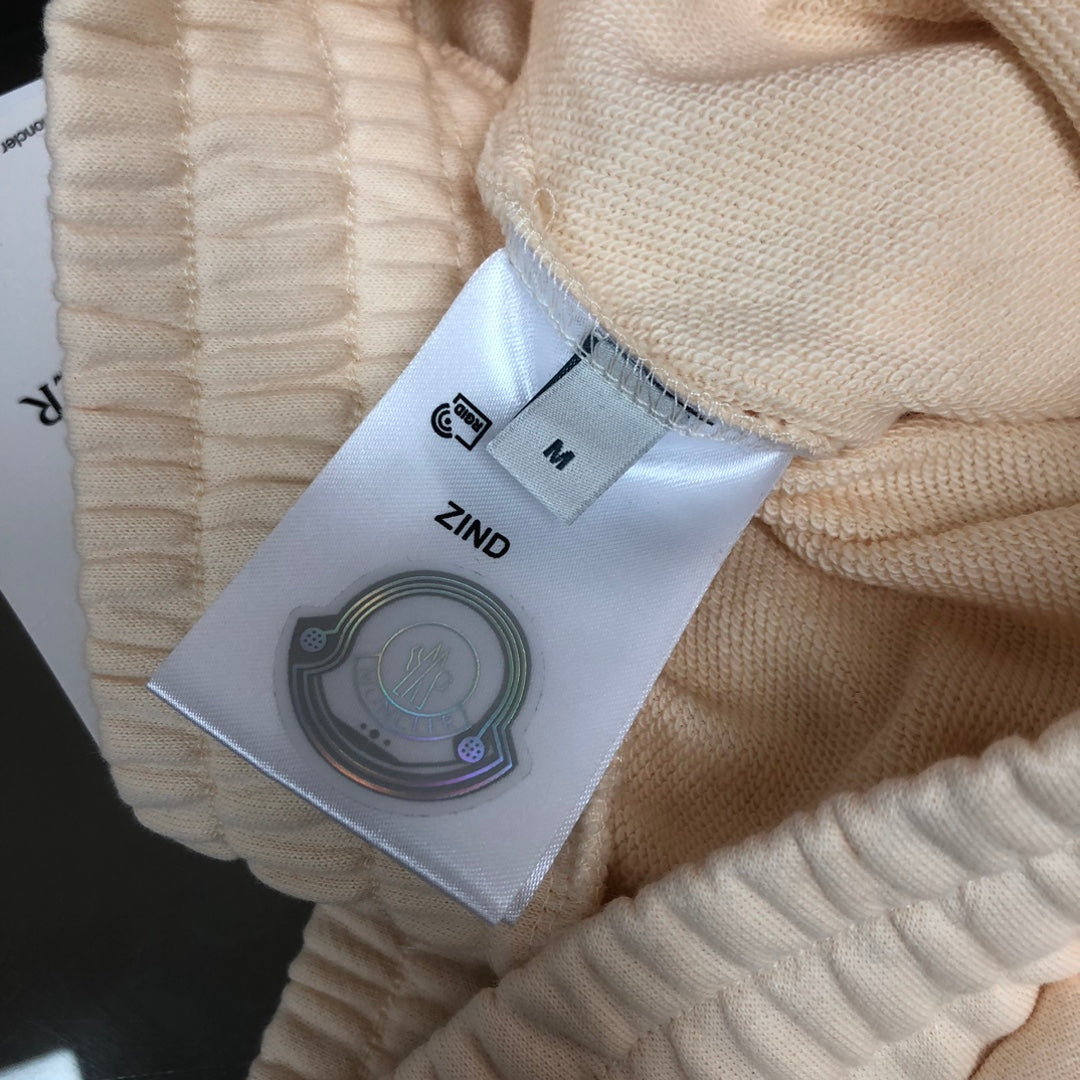 Cream shorts with fabric tag showing size “M” and label “ZIND”