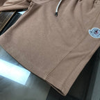 Stone Island tan shorts with visible side seam stitching and round logo patch