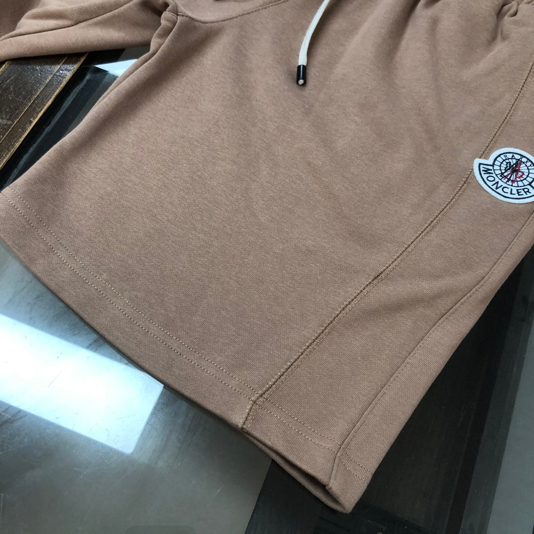 Stone Island tan shorts with visible side seam stitching and round logo patch
