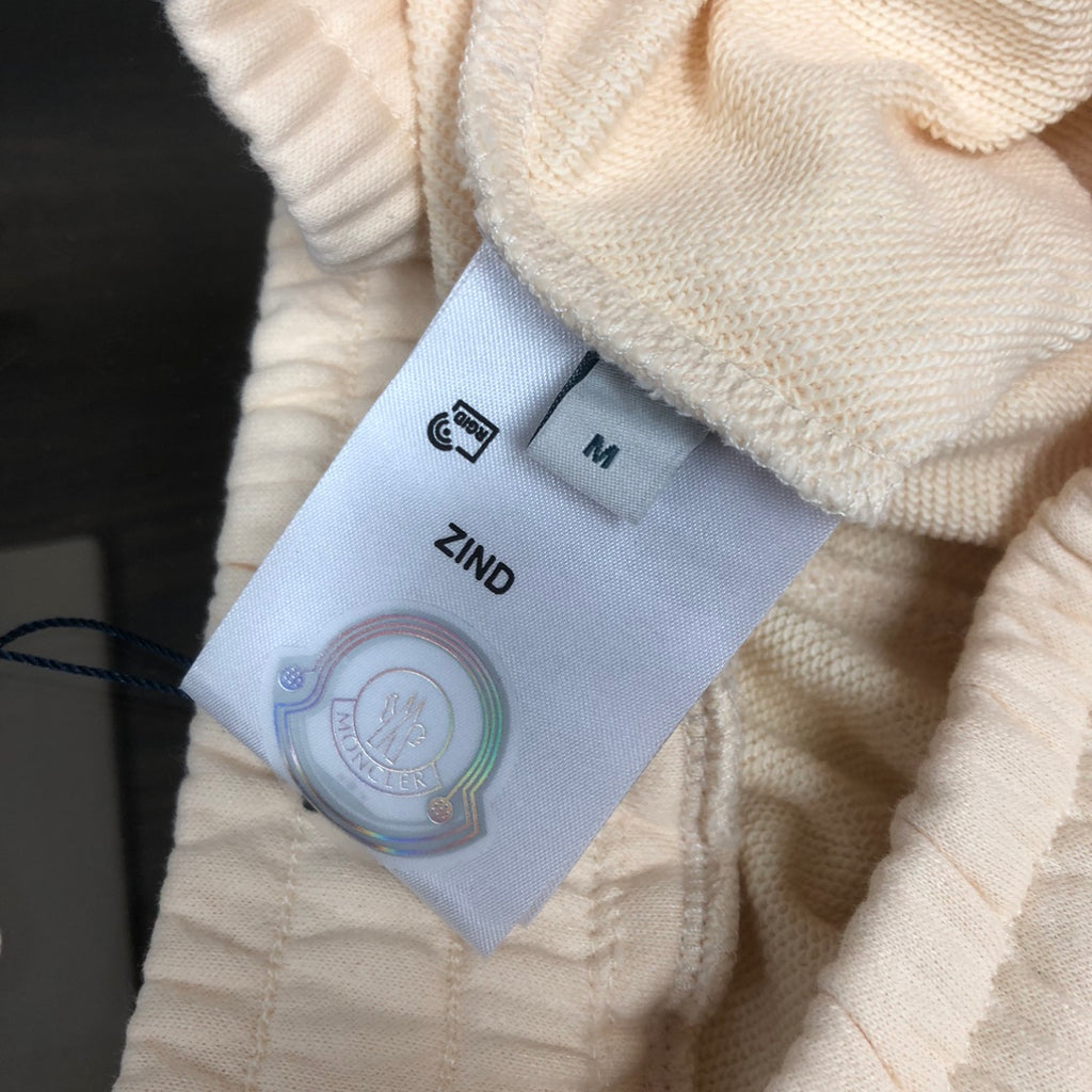 Cream shorts fabric with inner care label and attached product tags
