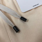 Cream shorts drawstring cords with small black end tags