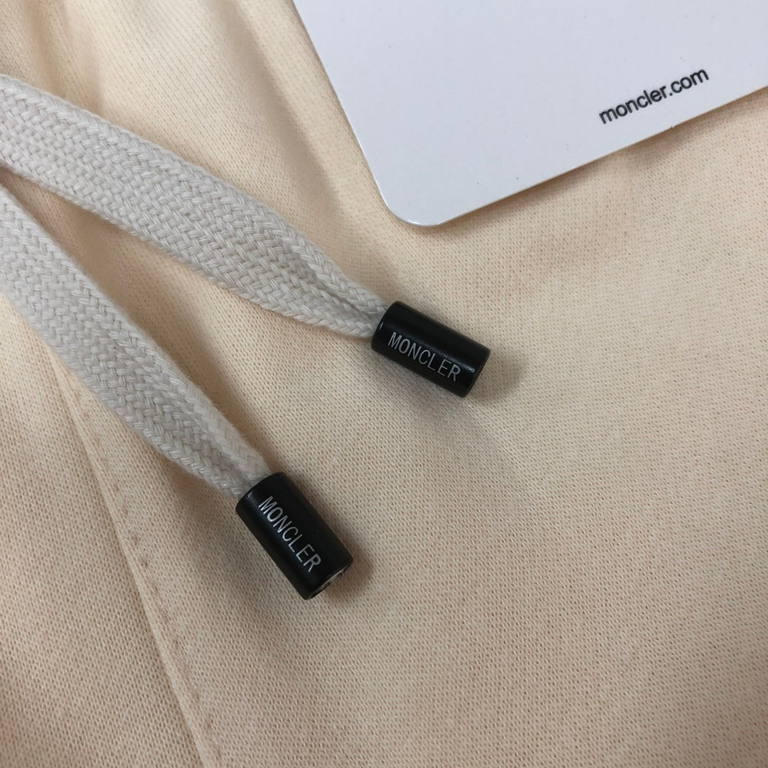 Cream shorts drawstring cords with small black end tags