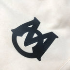 Cream shorts fabric with large black logo graphic on the front