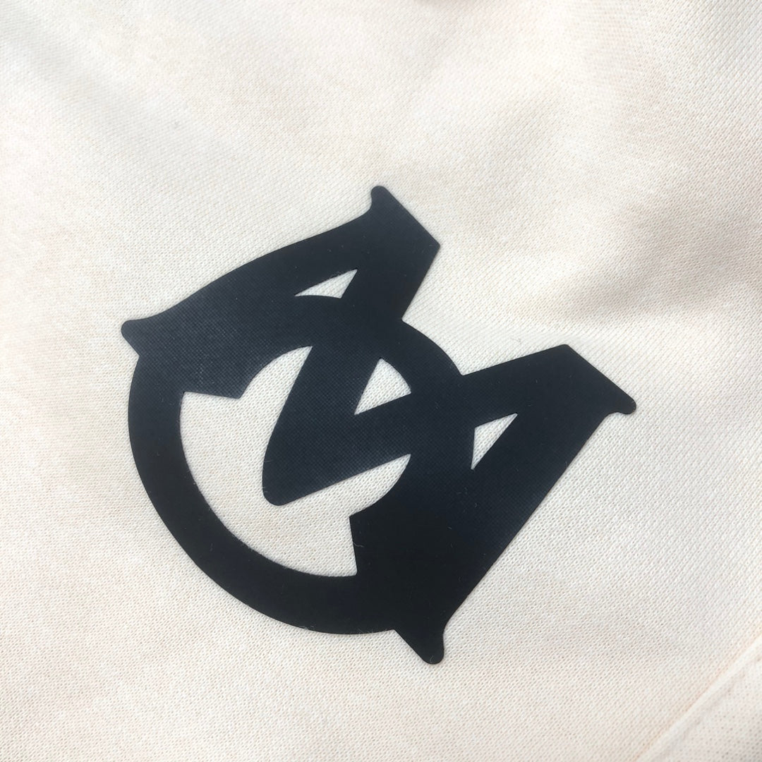 Cream shorts fabric with large black logo graphic on the front