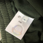Dark green shorts with size label marked ZIND and size M tag