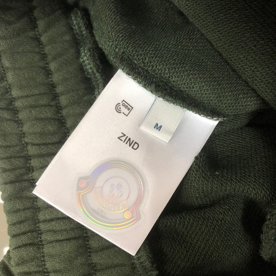Dark green shorts with size label marked ZIND and size M tag